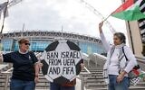 Pro-Palestinian activists protest with a football-shaped sign and a Palestinian flag outside Wembley Stadium to demand that the Football Association issue a public statement calling for the Israeli Football Association (IFA) to be suspended from participation in UEFA and FIFA tournaments, on October 2, 2025 in London, United Kingdom. (Mark Kerrison/In Pictures via Getty Images via JTA)